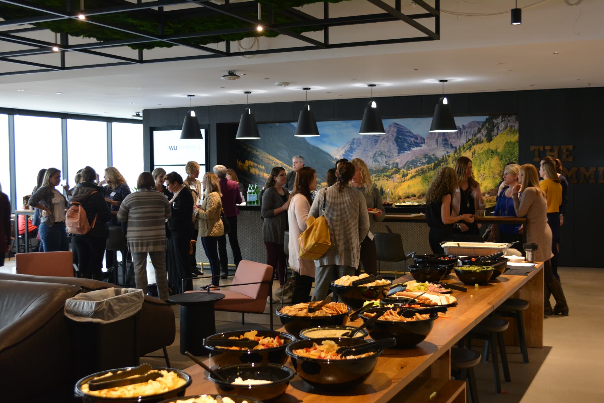 Executive Voices attendees connecting over refreshments between conversations